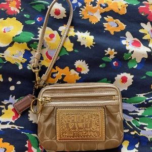 Gold and tan Coach wristlet